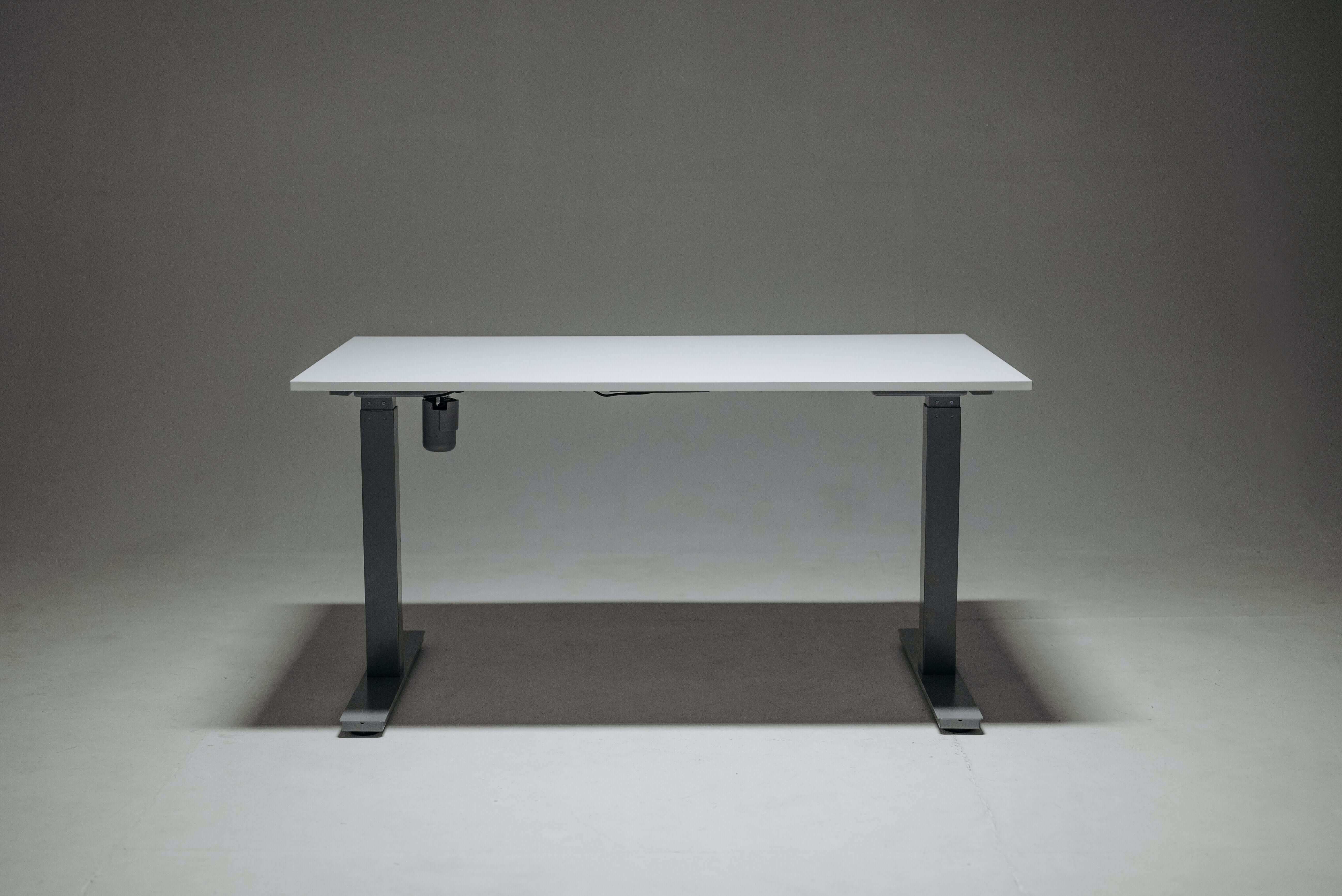 Modern workplace with height-adjustable desks arranged for employee use