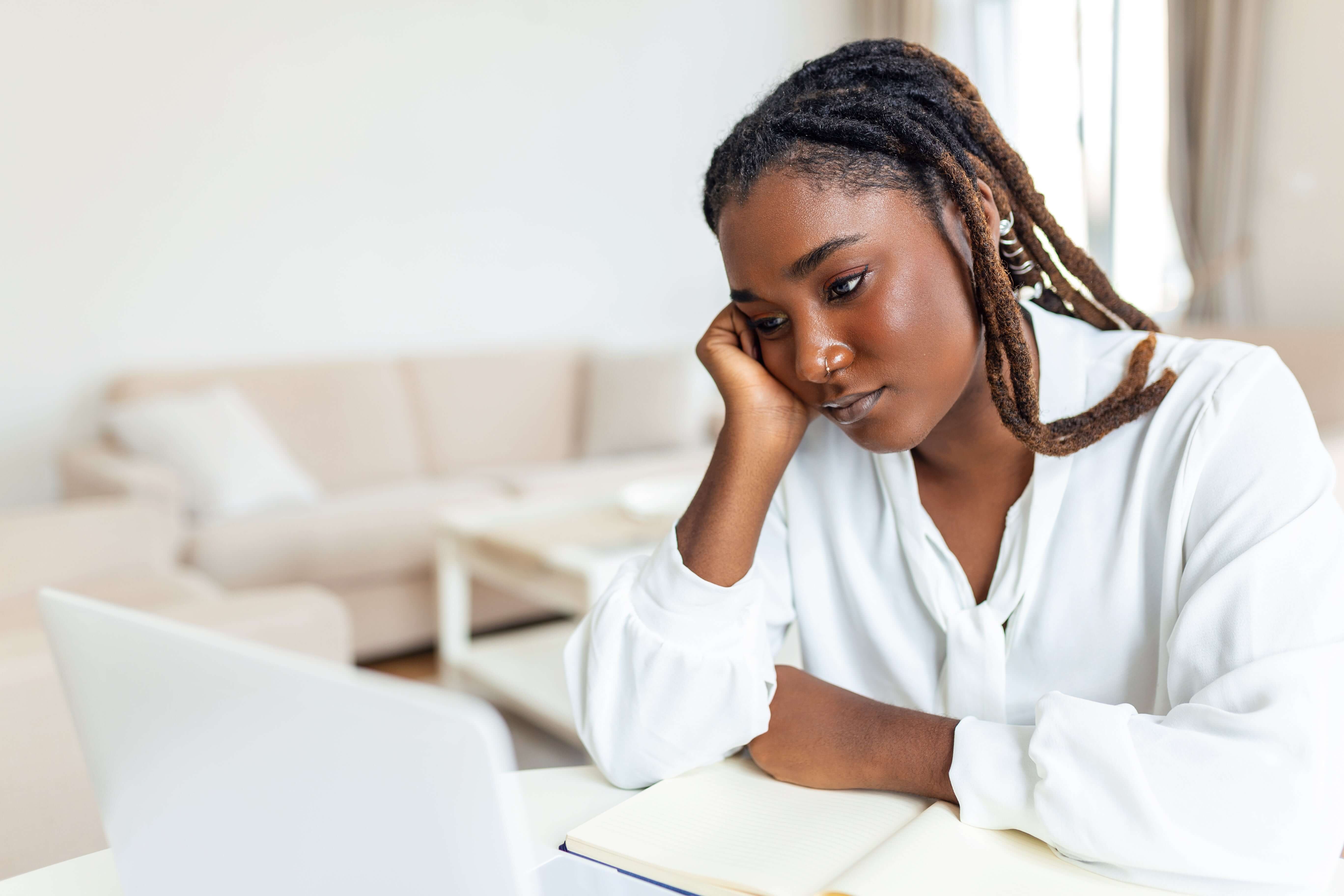Employee reflecting at a desk in a quiet office workspace