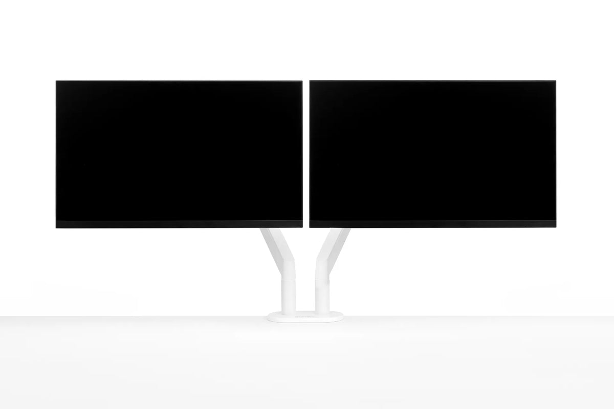 Two black monitors mounted side by side on a white dual monitor arm against a white background