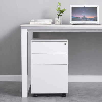 White office desk with a filing cabinet against a gray wall.